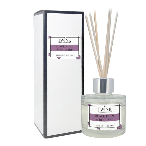 Black Plum & Rhubarb reed diffuser by Twink Candle Company, a 100ml glass bottle with reeds beside its gift box