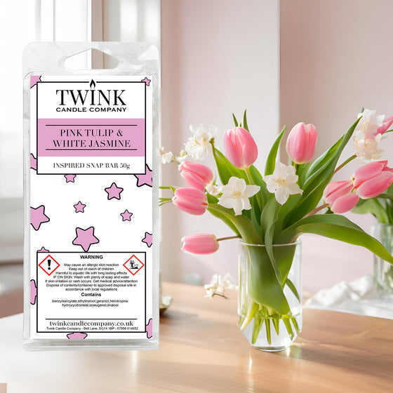 Pink Tulip & White Jasmine inspired soy wax melt snap bar by Twink Candle Company, beside a vase of pink tulips and jasmine