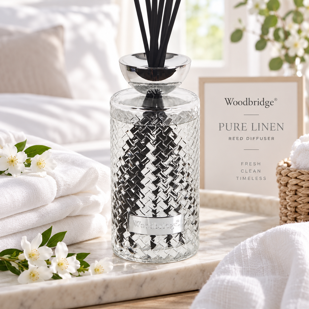 Woodbridge Pure Linen 1000ml reed diffuser — clear glass bottle with rattan reeds in a fresh, clean home setting