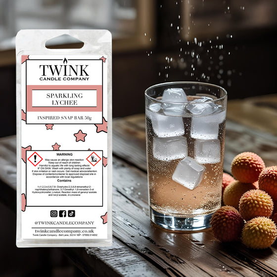 Sparkling Lychee inspired soy wax melt snap bar by Twink Candle Company, beside a glass of iced drink and fresh lychees