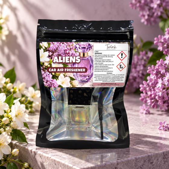 Aliens car air freshener by Twink Candle Company, packet styled in a home setting