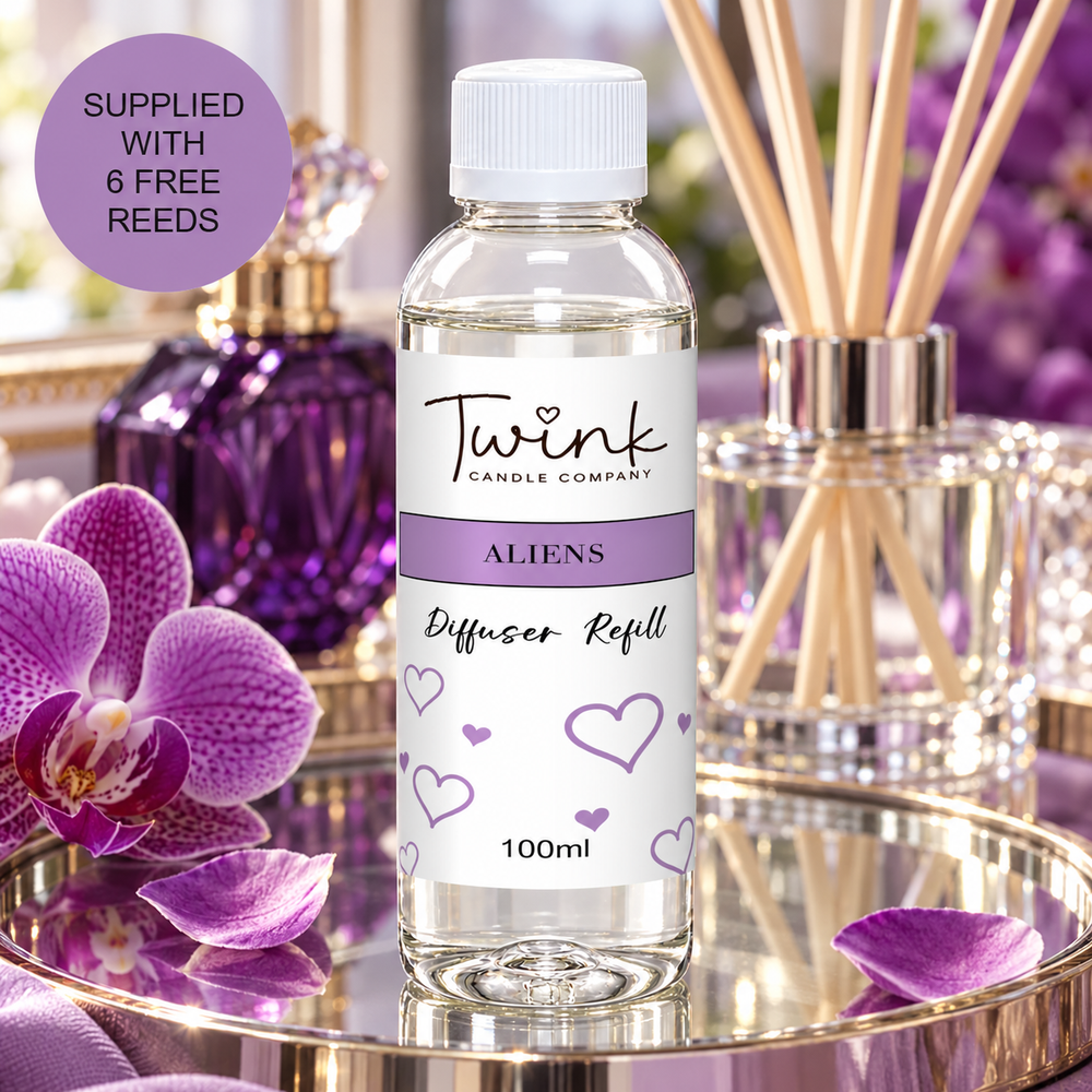 Aliens reed diffuser refill by Twink Candle Company, a 100ml bottle on a mirrored tray with purple orchids and a perfume bottle