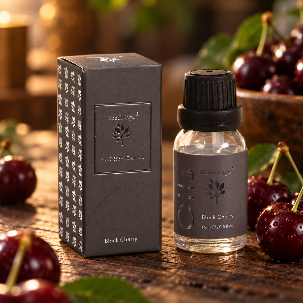 Woodbridge Black Cherry essential oil 15ml bottle and box on rustic dark wood with fresh dark cherries
