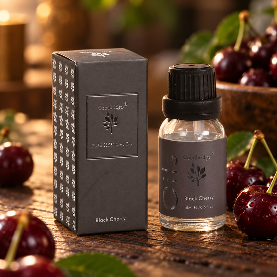 Woodbridge Black Cherry essential oil 15ml bottle and box on rustic dark wood with fresh dark cherries