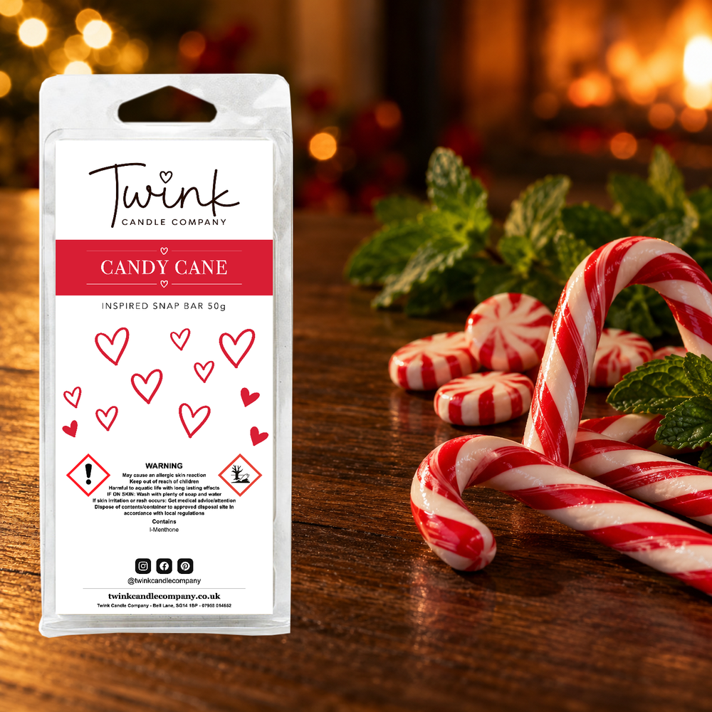 Candy Cane inspired soy wax melt snap bar by Twink Candle Company, stood on a dark wood table beside candy canes, peppermint swirls and fresh mint