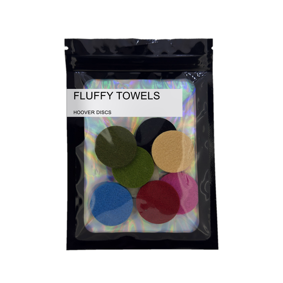 Pack of 8 Fluffy Towels scented hoover discs in its sealed black foil packet on a plain white background
