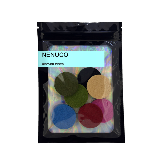 Pack of 8 Nenuco scented hoover discs in its sealed black foil packet on a plain white background