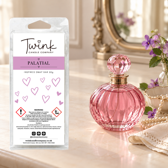 Palatial inspired soy wax melt snap bar by Twink Candle Company, standing on a cream dressing table beside a pink glass perfume bottle
