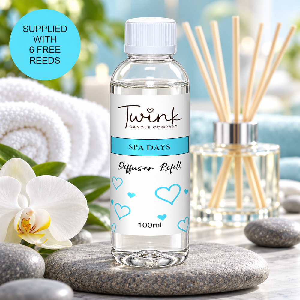Spa Days reed diffuser refill by Twink Candle Company, a 100ml bottle on a stone slab with rolled white towels and a white orchid