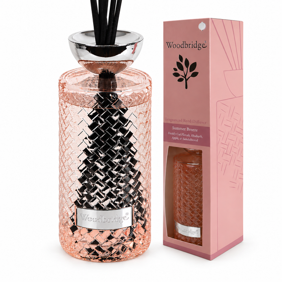 Woodbridge Summer Breeze 1000ml reed diffuser in a pink woven glass bottle with black reeds beside its pink gift box on a plain white background