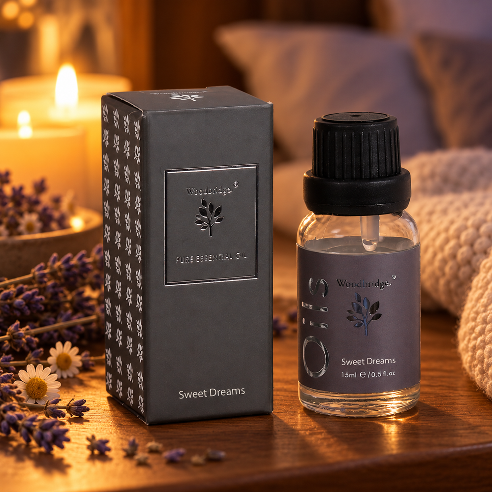 Woodbridge Sweet Dreams essential oil 15ml bottle and box on a bedside table with lavender, chamomile and candlelight