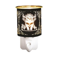 Highland cow black plug-in wax and oil burner by Twink Candle Company, shown lit with a highland cow design