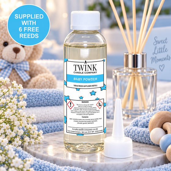 Baby Powder reed diffuser refill by Twink Candle Company, a 100ml bottle beside a soft teddy bear and spring blossom