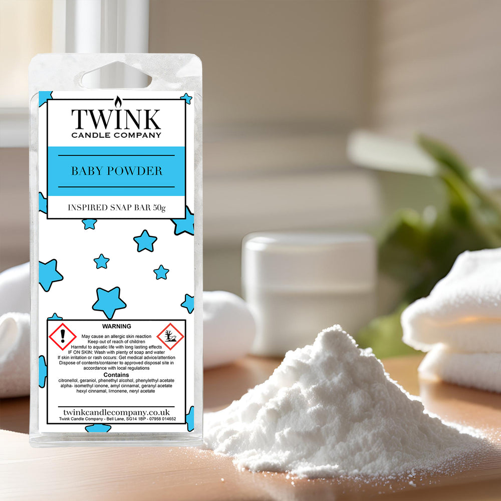 Baby Powder soy wax melt snap bar by Twink Candle Company, beside a soft mound of powder and a folded white towel