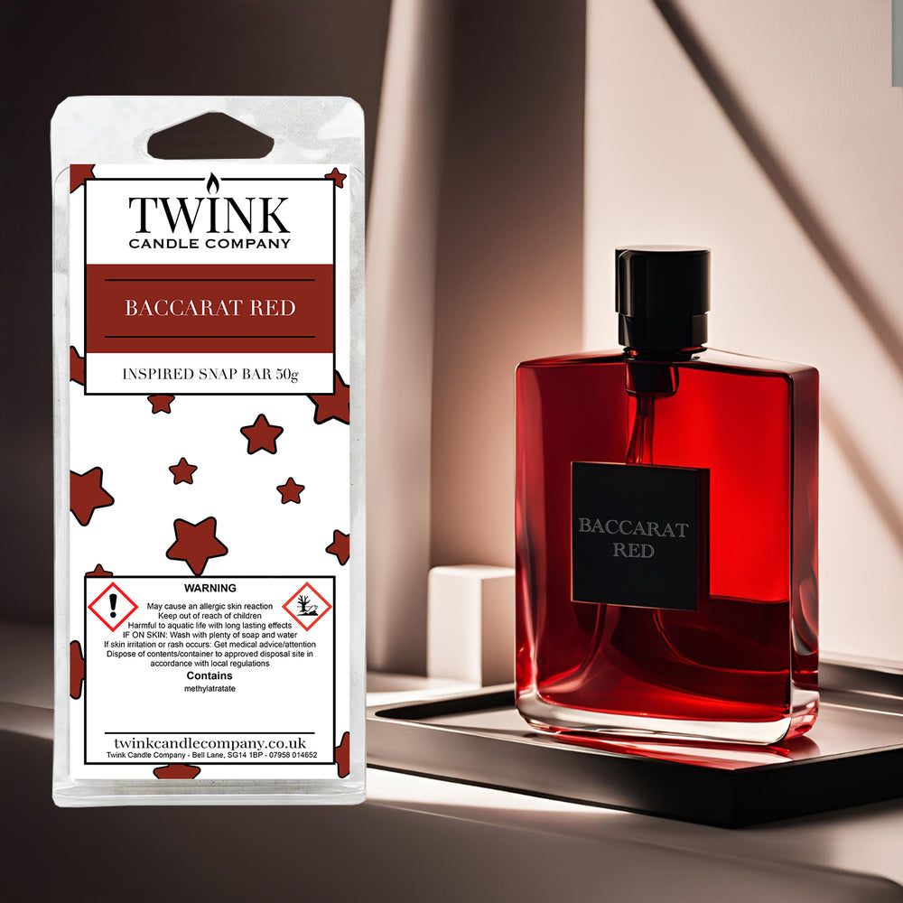 Baccarat Red soy wax melt snap bar by Twink Candle Company, beside a deep red perfume bottle on a dark polished surface