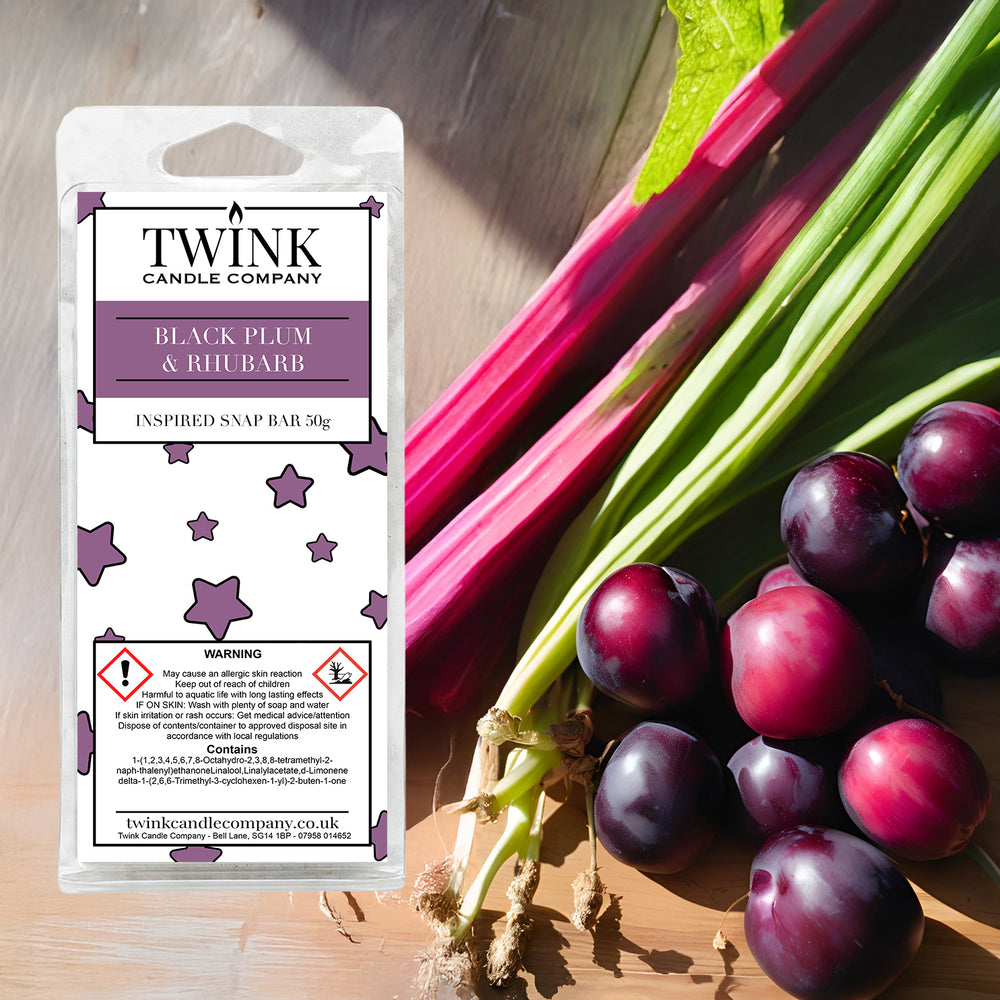 Black Plum & Rhubarb soy wax melt snap bar by Twink Candle Company, with fresh rhubarb stalks and dark plums on a wooden board