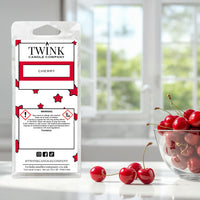 Cherry inspired soy wax melt snap bar by Twink Candle Company, with fresh cherries and a bowl by a window