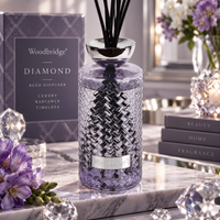 Woodbridge Diamond 1000ml reed diffuser — clear glass bottle with rattan reeds in an elegant home setting