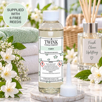 Fairy reed diffuser refill by Twink Candle Company, a 100ml bottle in a fresh, cosy home setting with white blossom
