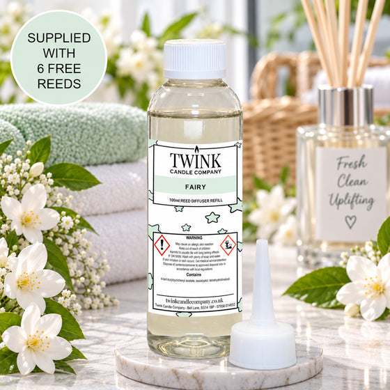 Fairy reed diffuser refill by Twink Candle Company, a 100ml bottle in a fresh, cosy home setting with white blossom