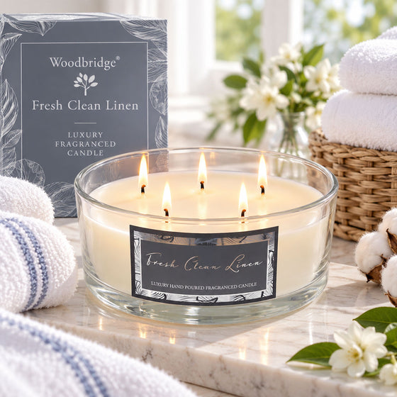 Woodbridge Fresh Clean Linen 5-wick 990g candle bowl — large frosted glass bowl candle glowing in a fresh, clean home setting