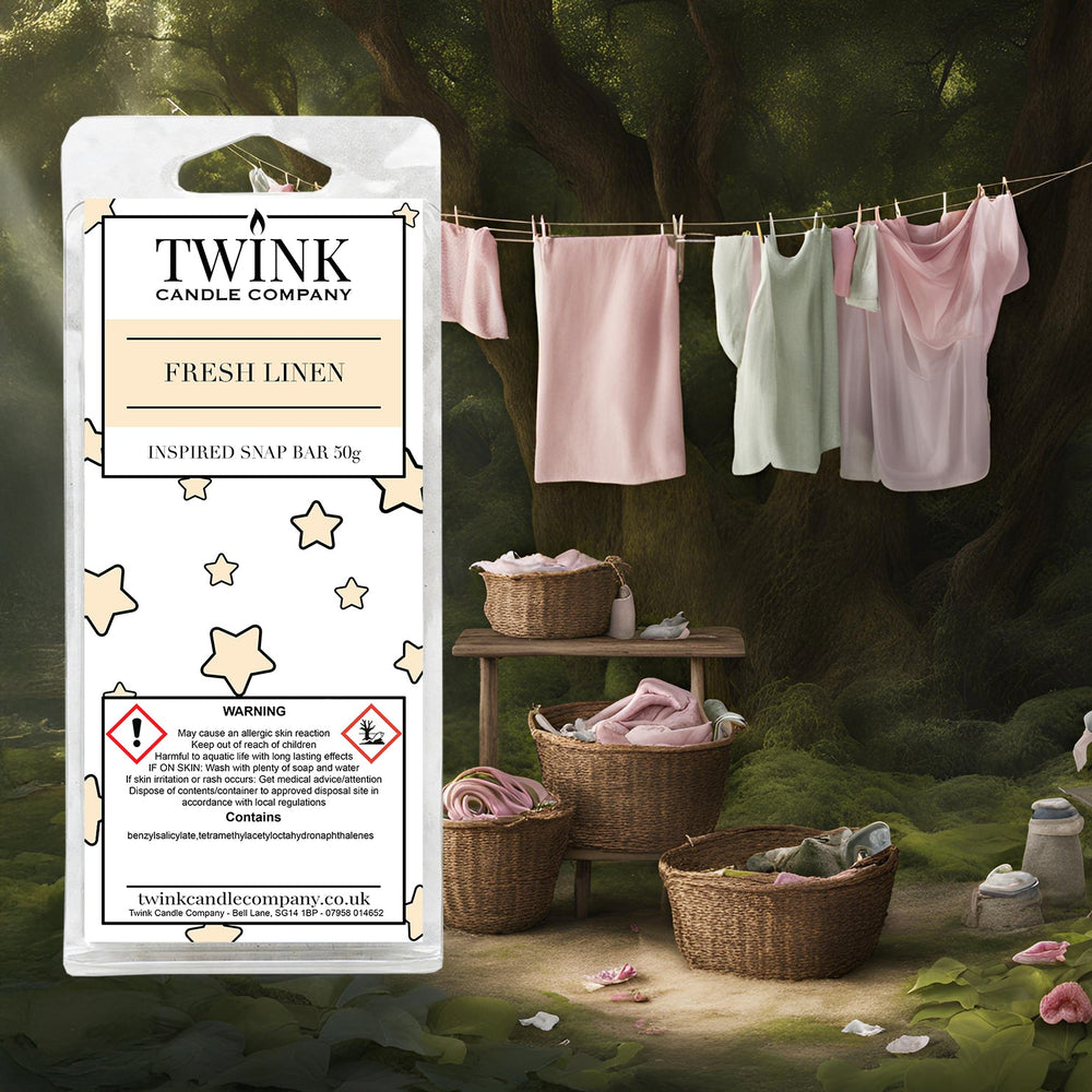Fresh Linen inspired soy wax melt snap bar by Twink Candle Company, with laundry drying on a washing line beside wicker baskets