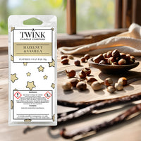 Hazelnut & Vanilla inspired soy wax melt snap bar by Twink Candle Company, with a bowl of hazelnuts and vanilla pods