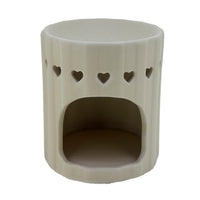 Heart cutout cream tumbler wax and oil burner by Twink Candle Company, showing the tea light opening