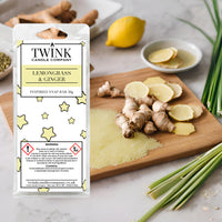 Lemongrass & Ginger soy wax melt snap bar by Twink Candle Company, with ginger root, lemongrass stalks and lemon on a wooden board