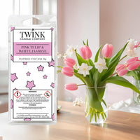 Pink Tulip & White Jasmine inspired soy wax melt snap bar by Twink Candle Company, beside a vase of pink tulips and jasmine