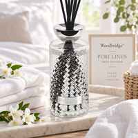Woodbridge Pure Linen 1000ml reed diffuser — clear glass bottle with rattan reeds in a fresh, clean home setting