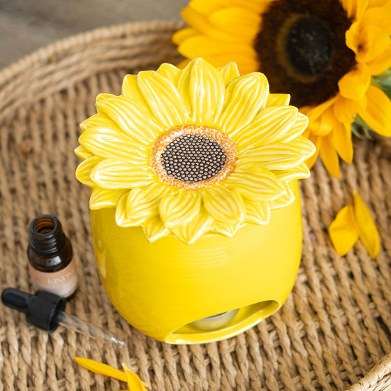 Sunflower wax and oil burner by Twink Candle Company, styled with fresh sunflowers