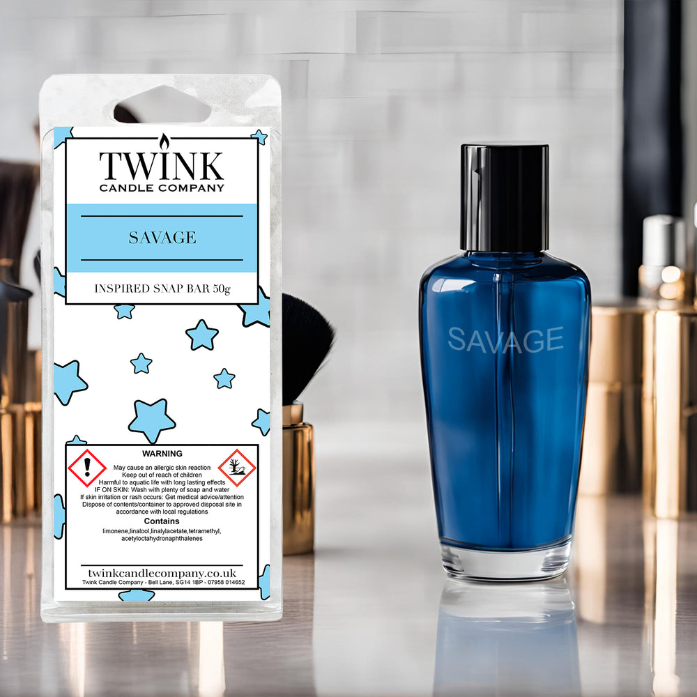 Savage inspired soy wax melt snap bar by Twink Candle Company, beside a deep blue glass perfume bottle