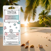 She Sells Sea Shells inspired soy wax melt snap bar by Twink Candle Company, on a sunset beach with palm trees and shells
