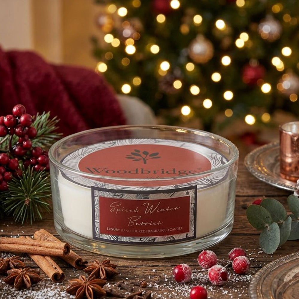 Woodbridge Spiced Winter Berries 5-wick 990g candle bowl — large frosted glass bowl candle glowing in a warm festive setting