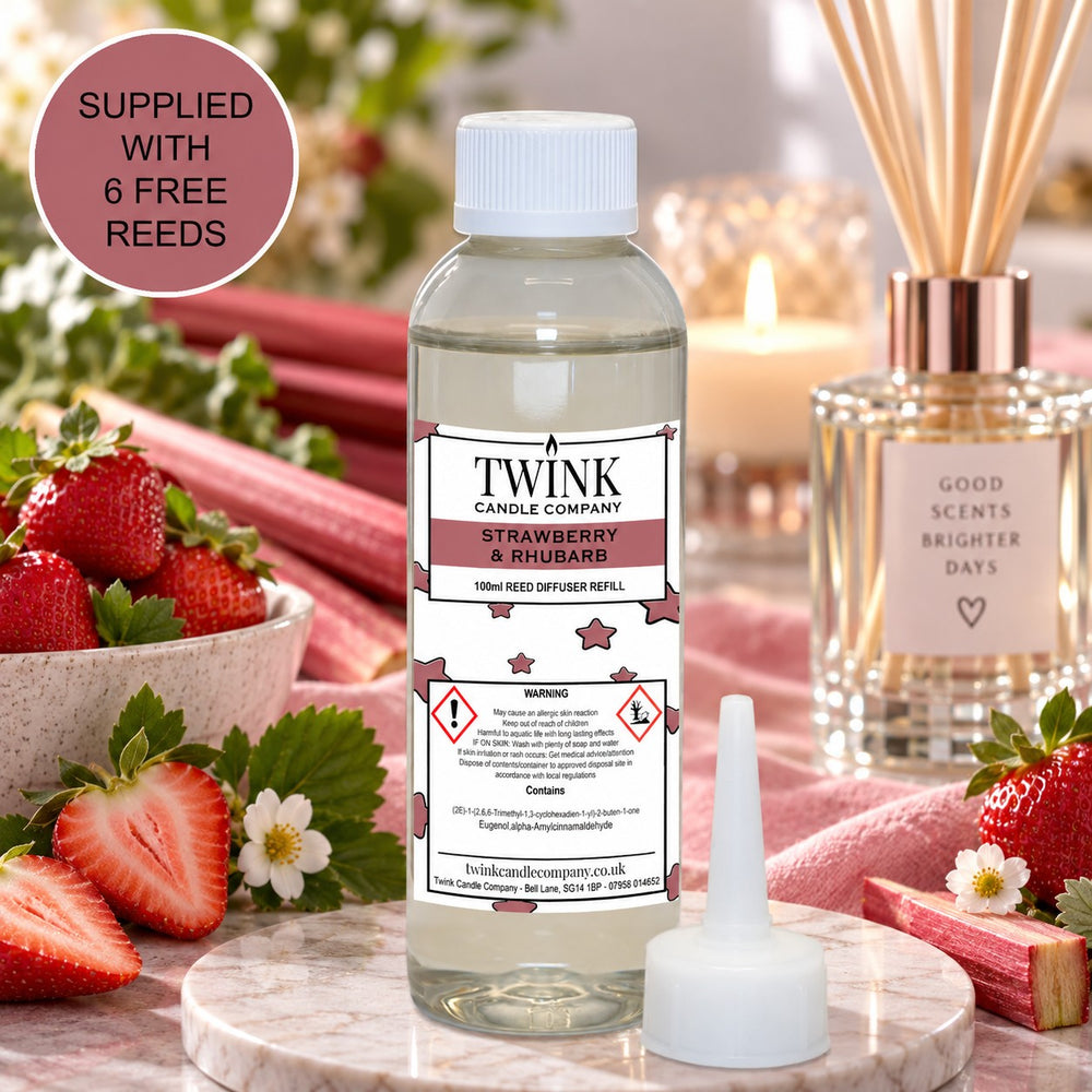 Strawberry & Rhubarb reed diffuser refill by Twink Candle Company, a 100ml bottle surrounded by fresh strawberries and rhubarb