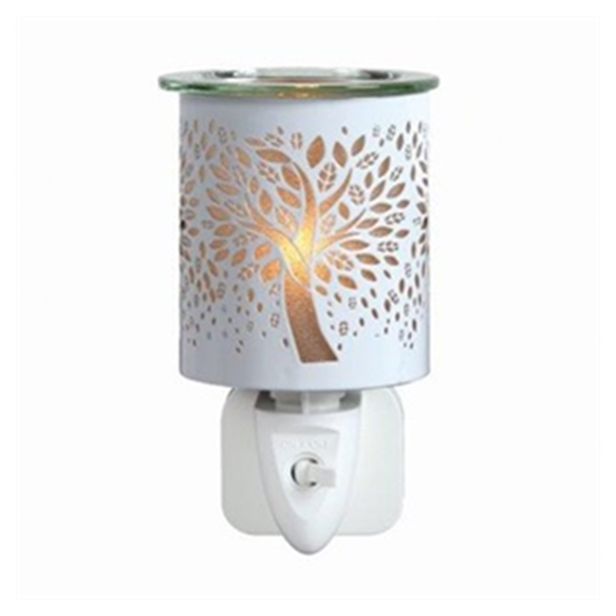White tree of life cutout plug-in wax and oil burner by Twink Candle Company, shown lit