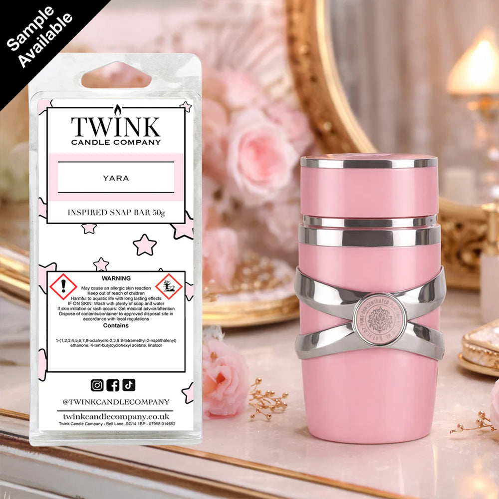 Yara inspired soy wax melt snap bar by Twink Candle Company, beside a pink and silver perfume bottle on a dressing table