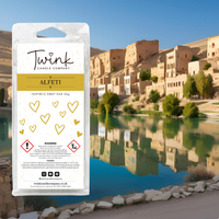 Alfeti inspired soy wax melt snap bar by Twink Candle Company, shown against a desert oasis with stone buildings and still water