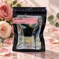 Aliens car air freshener by Twink Candle Company, hanging vent diffuser styled in a home setting
