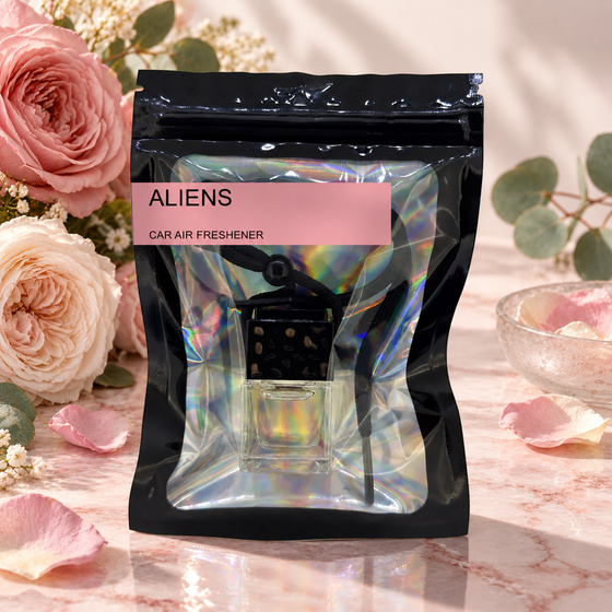 Aliens car air freshener by Twink Candle Company, hanging vent diffuser styled in a home setting