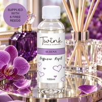 Aliens reed diffuser refill by Twink Candle Company, a 100ml bottle on a mirrored tray with purple orchids and a perfume bottle