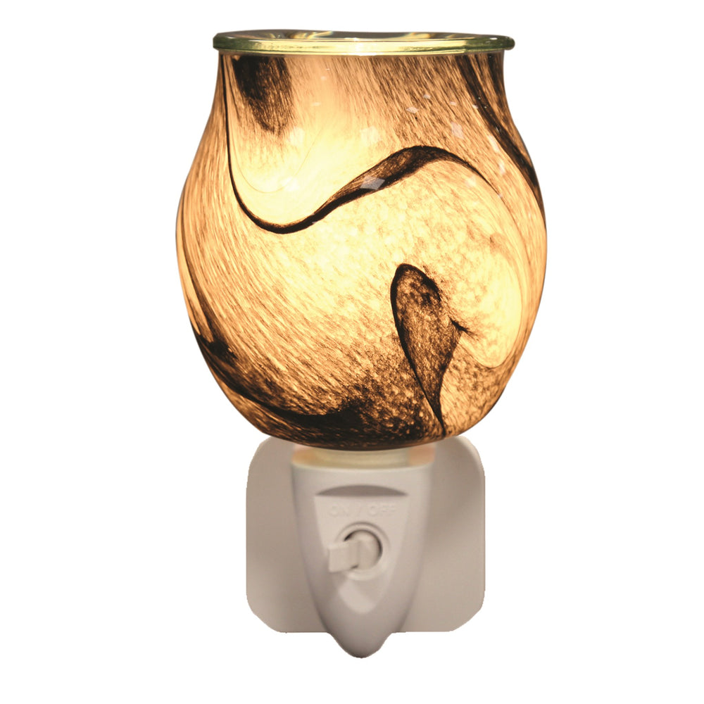 Grey swirl glass plug-in wax melt burner glowing warm on a white background
