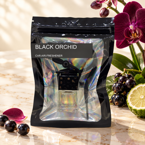 Black Orchid car air freshener by Twink Candle Company, hanging vent diffuser styled in a home setting