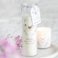 Butterflies Appear tube candle by Twink Candle Company, styled on a marble stand with pink blossom