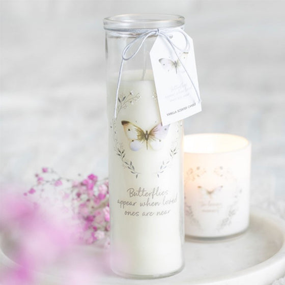 Butterflies Appear tube candle by Twink Candle Company, styled on a marble stand with pink blossom