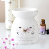 Butterflies Appear wax and oil burner by Twink Candle Company, shown with fragrance oils and pink blossom