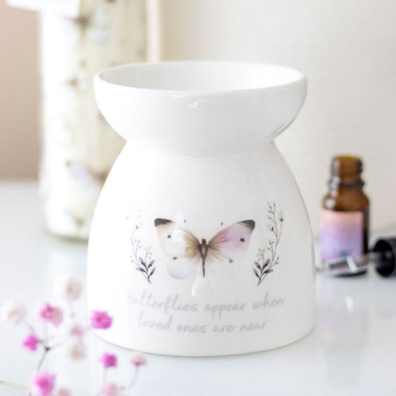 Butterflies Appear wax and oil burner by Twink Candle Company, shown with fragrance oils and pink blossom