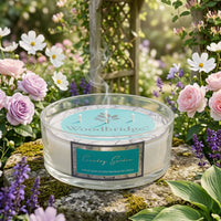 Woodbridge Country Garden 5-wick 990g candle bowl — large frosted glass bowl candle glowing in a fresh, floral home setting