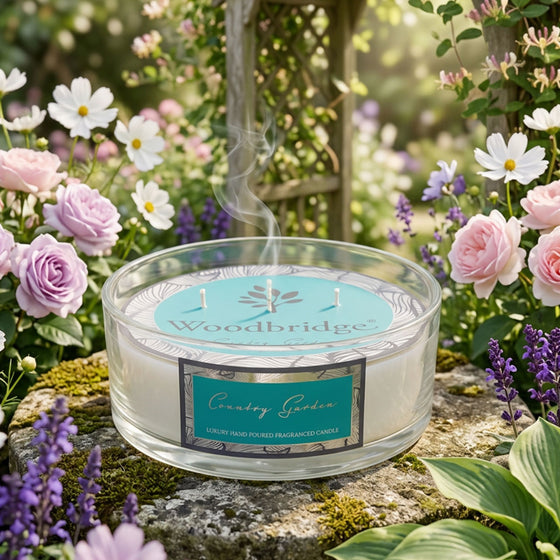 Woodbridge Country Garden 5-wick 990g candle bowl — large frosted glass bowl candle glowing in a fresh, floral home setting